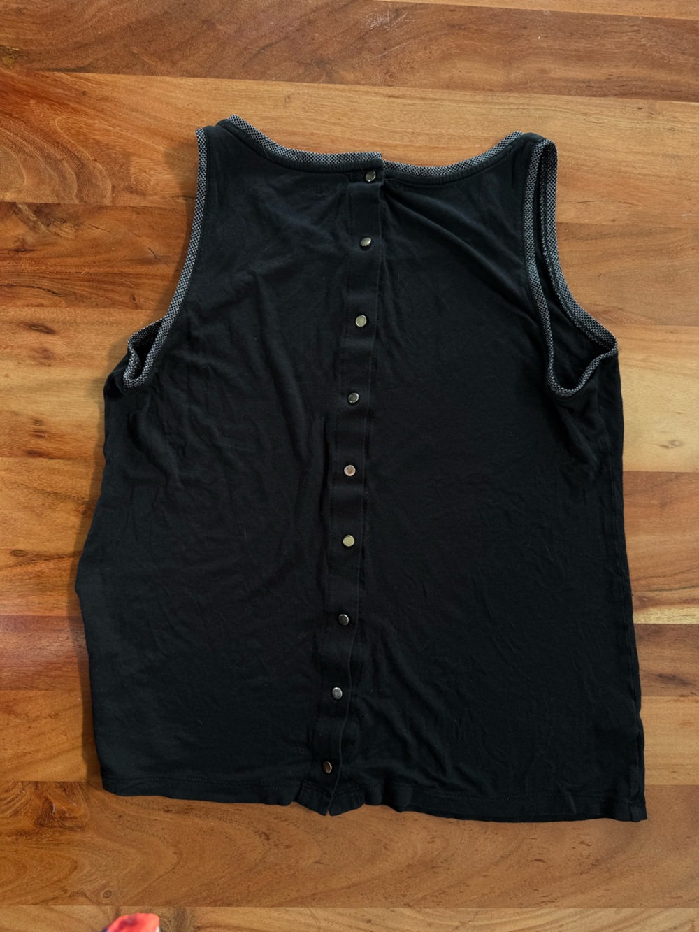 Black tank with silver buttons on back